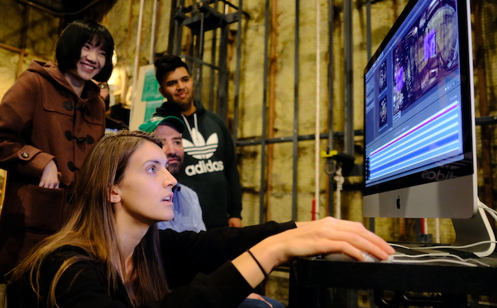 Students in studio looking at computer screen