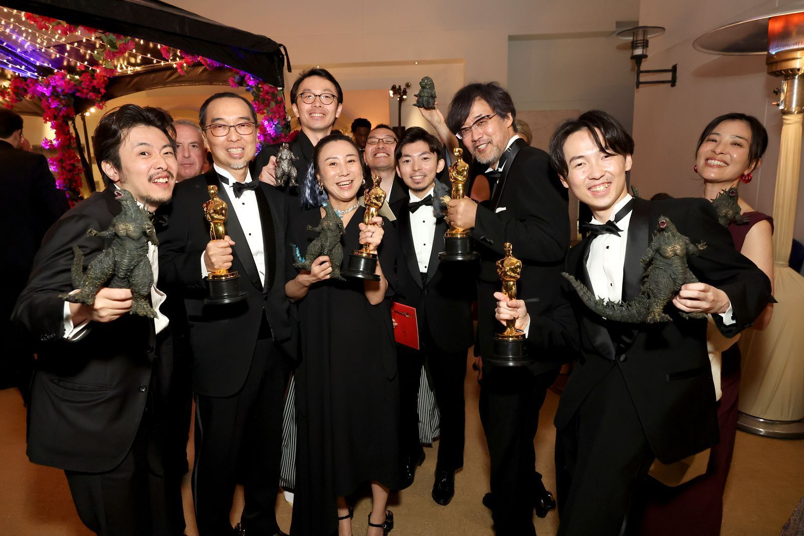 Godzilla Minus One Crew smiling holding their Oscars