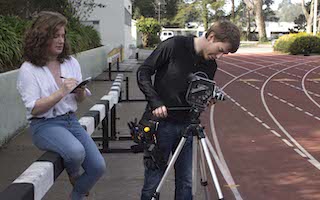 Students setting up camera at track