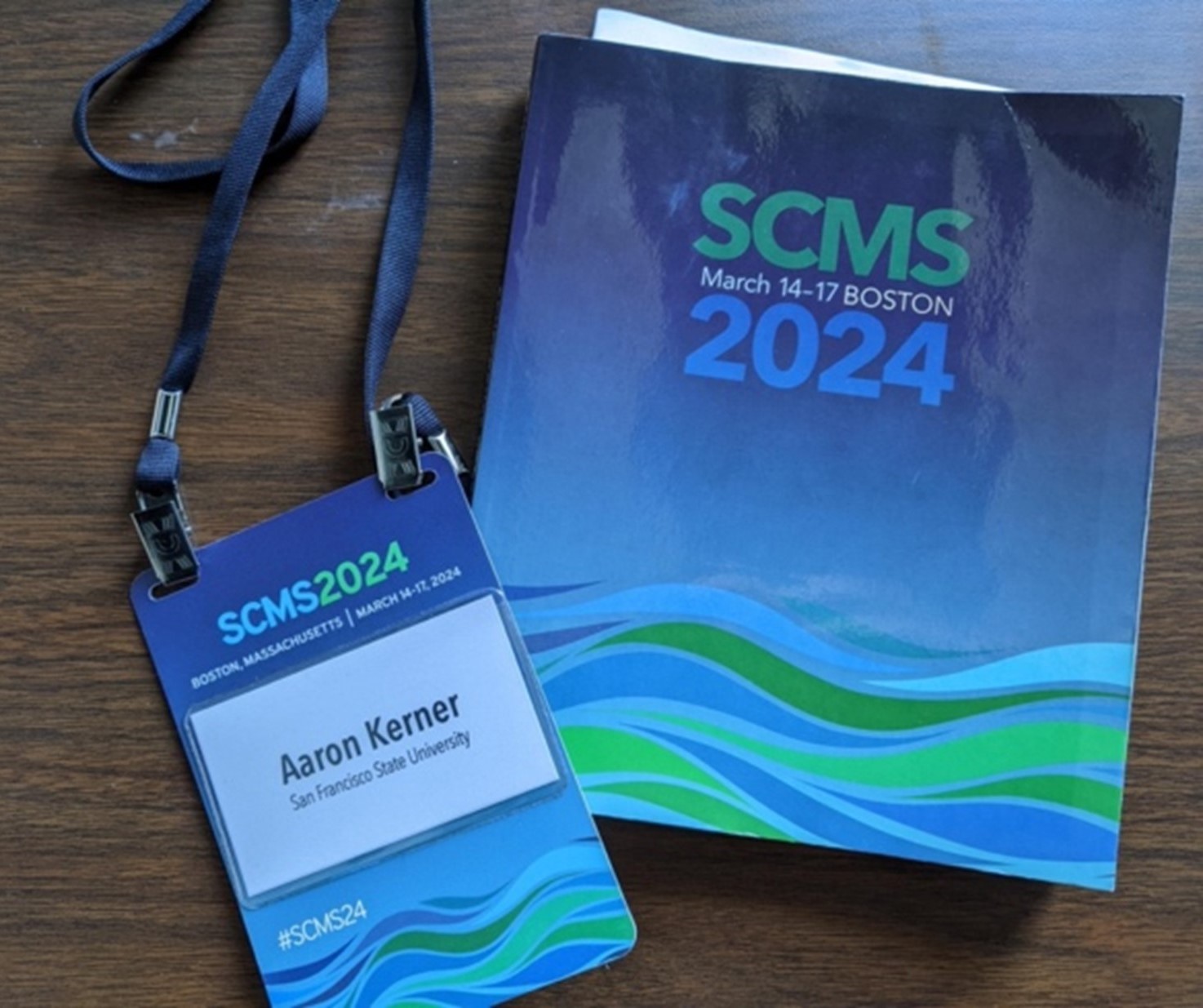The Society for Cinema and Media Studies Conference matching blue and green booklet and lanyard