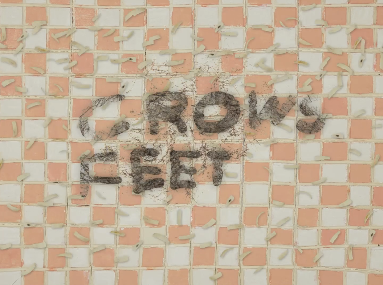 A checkered paper background, with the words "Crows Feet" crosshatched.